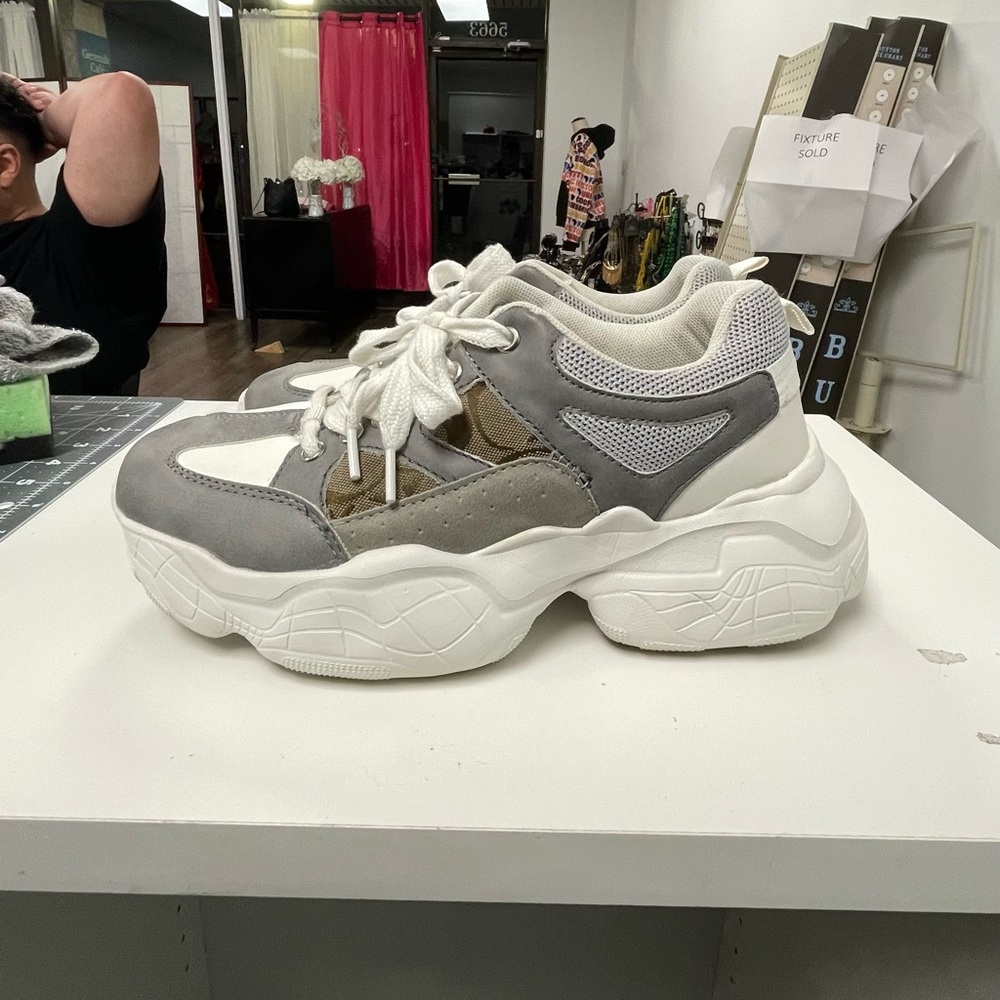 Chunky white sneakers with Coach pieces